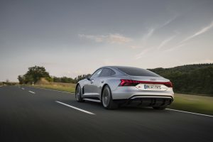 Audi e-tron GT driving down a road